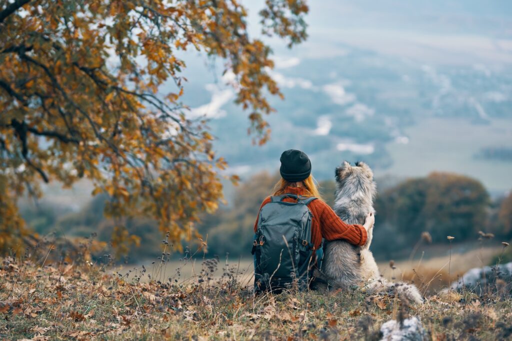 woman with dog nature autumn mountains trip