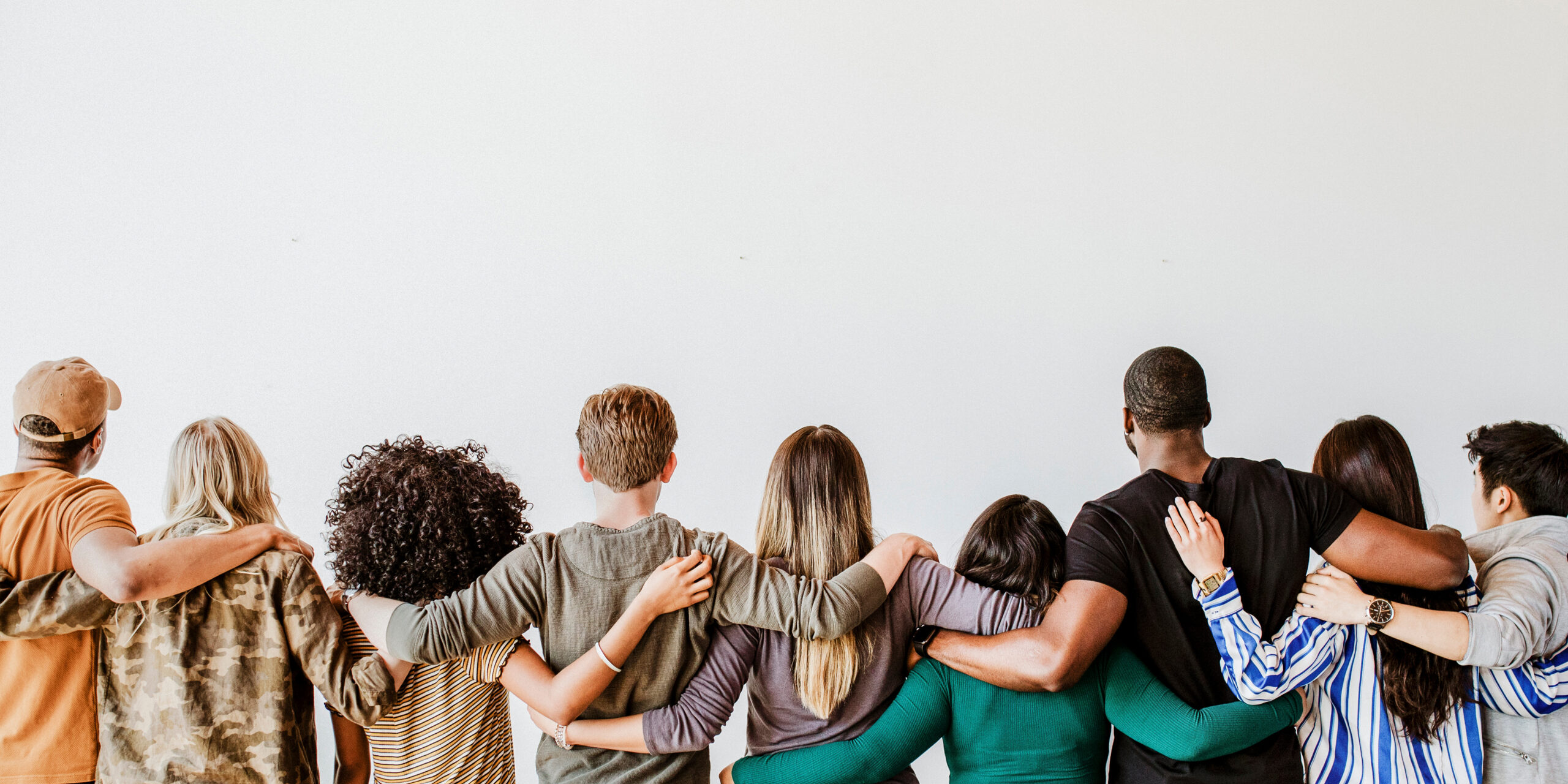 Rearview of diverse people hugging each other